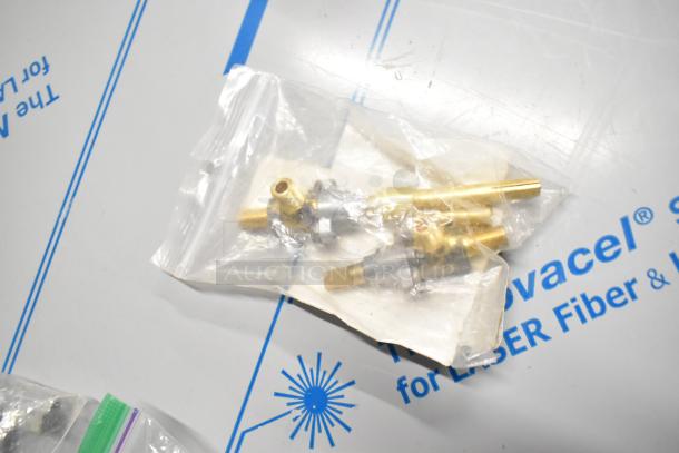Bag of brass valves and components, labeled as Garland/US Range 4530799, new condition, on a blue-marked background.