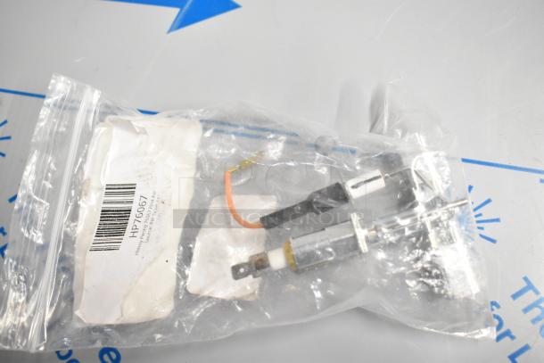 Plastic bag containing Henny Penny HP76067 Pilot Assembly Nat, with visible barcode and label inside, brand new condition.