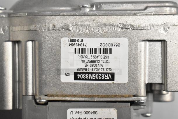 Metallic valve unit with labels indicating "VR8205M8804" and technical specifications. Part of a new scratch and dent lot.