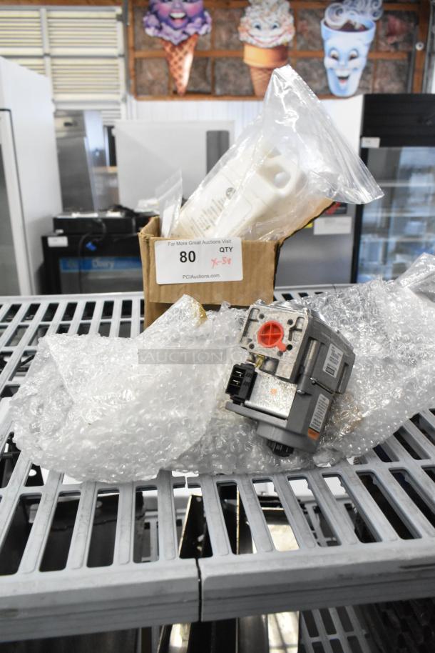 Box with new Cleveland 105784 component and other items, bubble-wrapped; tagged "QTY 5X." Includes metal legs, lubricating oil.