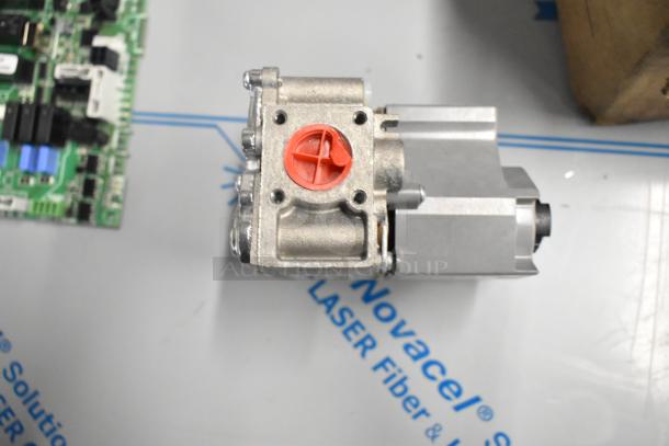 Cleveland 105784 Plt Asy;Nat;0.018 Intermittent component, new condition, featuring metal legs and visible ports.