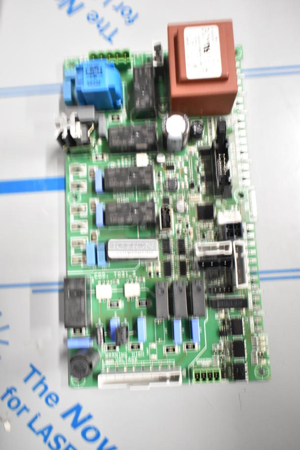 Blurred circuit board featuring capacitors and various electronic components, with a blue component marked "166 S2".