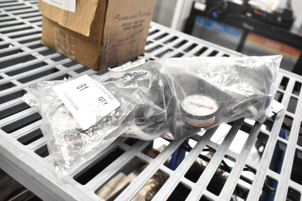 Brand new 3M VH3 Head Assembly in packaging, marked "QTY X2," with slight scratch and dent, on auction table.