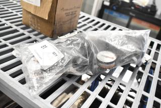 Brand new 3M VH3 Head Assembly in packaging, marked "QTY X2," with slight scratch and dent, on auction table.