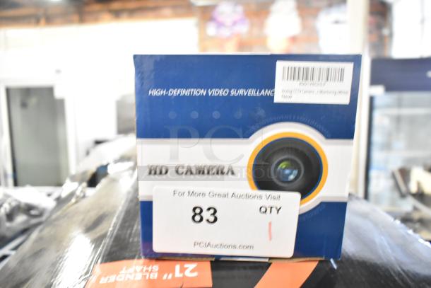 IN ORIGINAL BOX! Analog CCTV Camera, HD, new, in blue and white packaging with surveillance label, auction tag "83 QTY."