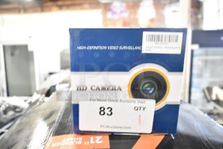 IN ORIGINAL BOX! Analog CCTV Camera, HD, new, in blue and white packaging with surveillance label, auction tag "83 QTY."