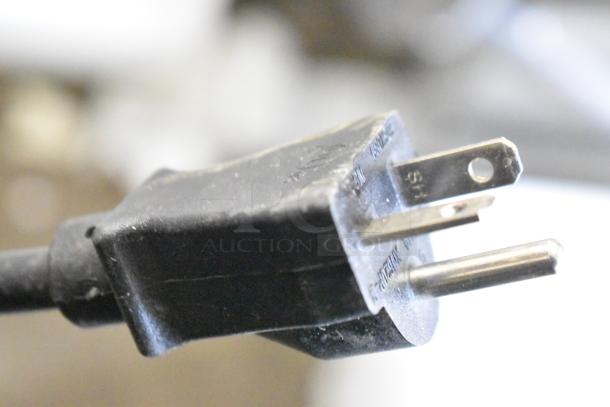 Close-up of a plug for Estella 348SM60 Spiral Dough Mixer, showing prongs and electrical specifications for 240 volts.
