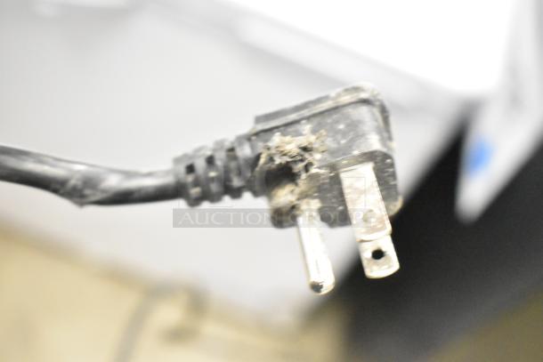 Damaged power plug of a KoolMore SCF-24C commercial chest freezer, 115 volts, brand new with scratches and dents.