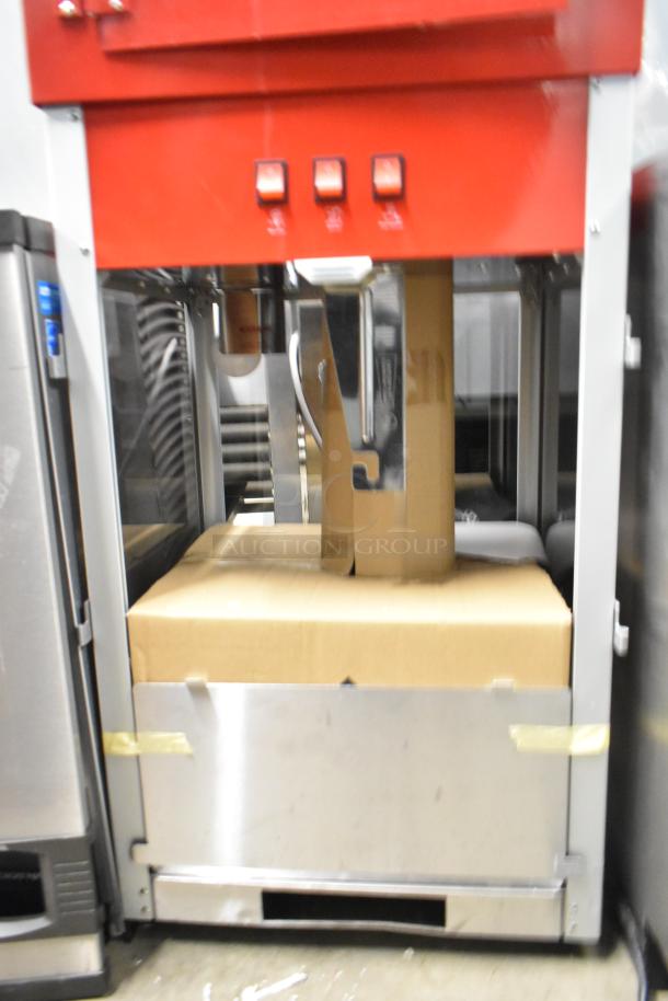 Brand new metal commercial popcorn machine and merchandising cart, red, with minor scratches and dents, boxed accessories included.