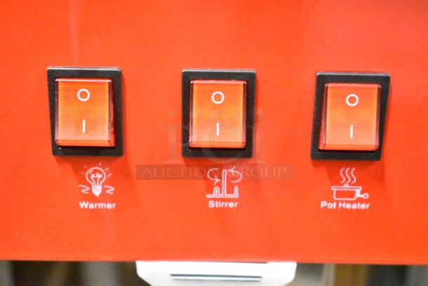 Red control panel of a commercial popcorn machine with switches labeled "Warmer," "Stirrer," and "Pot Heater."