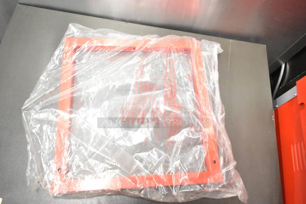 Brand new metal commercial popcorn machine and merchandising cart, scratch and dent condition, plastic-wrapped components visible.