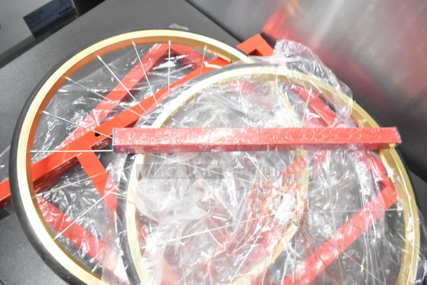 Brand new metal commercial popcorn machine parts in packaging, showing wheels and red metal frame components. Scratch and dent condition.