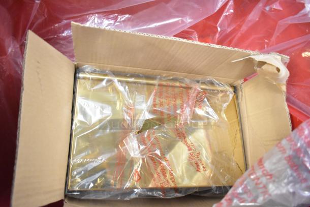Brand new metal commercial popcorn machine in box, scratch and dent condition, packaged securely with protective plastic.