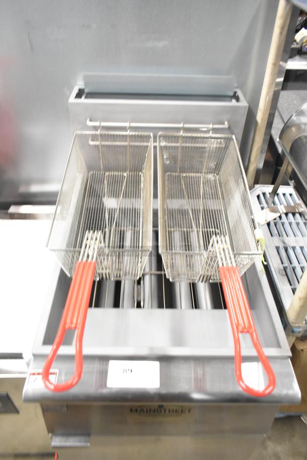 Stainless steel Mainstreet 541FF100L floor fryer with two metal fry baskets, 150,000 BTU, new scratch and dent condition.