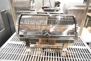 Stainless steel countertop chafing dish with roll-top lid, reflective finish, and sturdy legs in excellent condition.