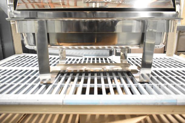 Stainless steel countertop chafing dish with sturdy legs, reflective surface, and modern design. Ideal for buffets.