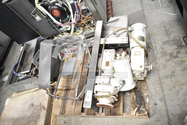 Lot includes Baldor motor and various metal pieces on a pallet. Motor shows wear. Tag labeled "95." Ideal for industrial use.
