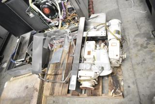 Lot includes Baldor motor and various metal pieces on a pallet. Motor shows wear. Tag labeled "95." Ideal for industrial use.