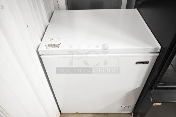 Magic Chef HMCF5W4 metal chest freezer with hinge lid, 115 volts, 1 phase. White exterior, branded badge visible.