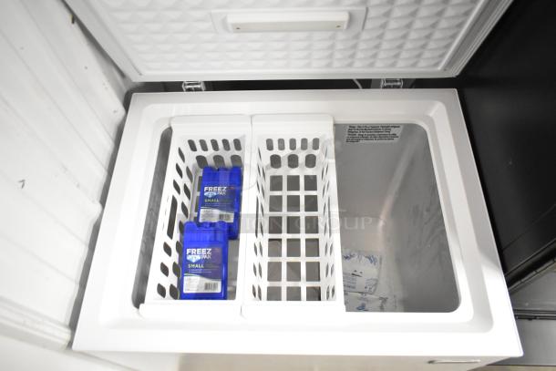 Magic Chef HMCF5W4 chest freezer with hinge lid, interior storage baskets, 115V, 1 phase. Clean and well-maintained.