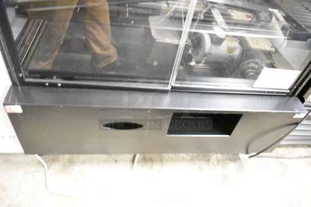 Marco Display Specialties metal bakery merchandiser cabinet for bagels, donuts, pastries; features glass front and sturdy base.