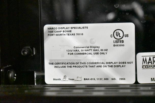 Label on Marco Display Specialties metal bakery cabinet, listing model number, voltage, wattage, and address information.
