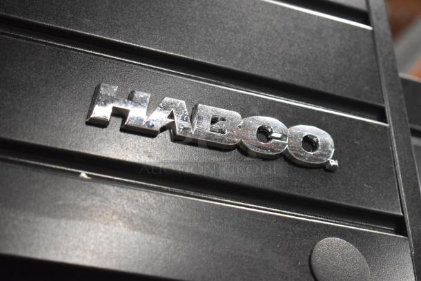 Habco SE18 cooler nameplate. Silver "Habco" logo on a black surface, indicating brand identity.