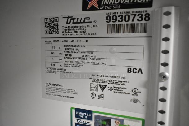 Label on a True GDM-41SL-48-HC-LD commercial cooler, showing specs: 115V, 1 Phase, R290 refrigerant, NSF/ANSI certified.