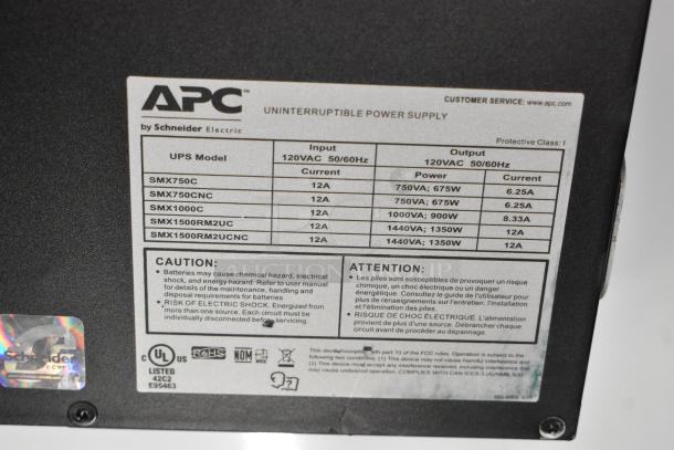 APC Uninterruptible Power Supply label showing models, input/output details, and safety warnings. Models include SMX750C, SMX1000C.