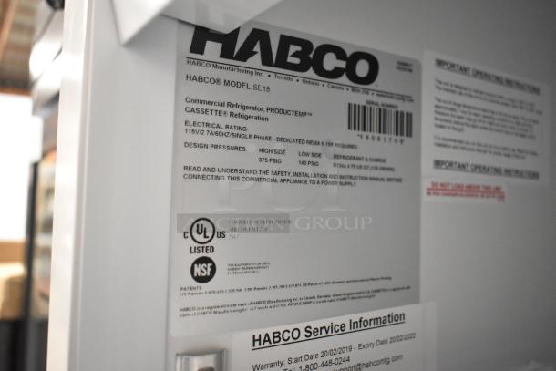 2019 Habco SE18 metal commercial cooler with single door, poly-coated racks, 115 volts, UL and NSF listed. Tags show model and specs.