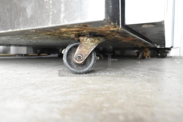 2020 Delfield 406P-STAR2 stainless steel undercounter cooler on commercial casters, 115V, 1 phase, visible rusting on caster.