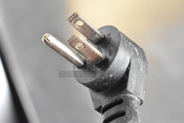 Close-up of a plug from a 2020 Delfield 406P-STAR2 single door undercounter cooler. Black cord, standard three-prong plug.