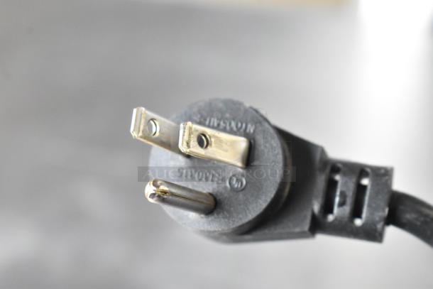 Close-up of a three-prong electrical plug for Delfield 406P-STAR2 undercounter cooler, suitable for 115 volts, 1 phase.