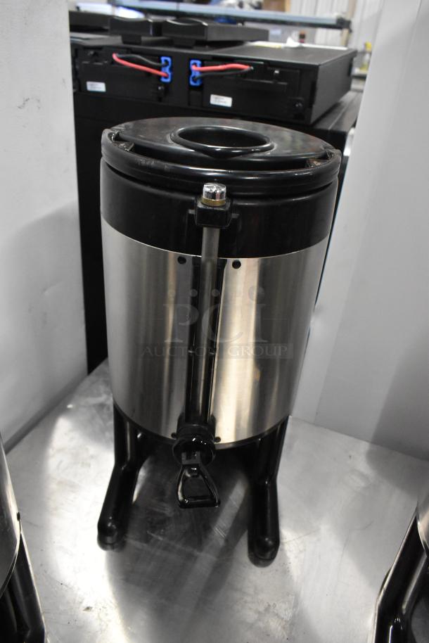 Fetco metal countertop beverage dispenser, stainless steel body with black accents, tap handle, excellent condition.