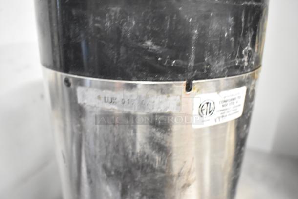 3 Fetco metal countertop beverage dispensers, stainless appearance, used condition. Label shows compliance to safety standards.