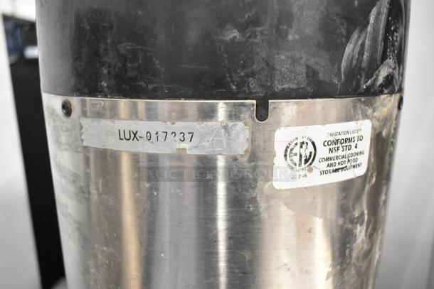 Fetco metal beverage dispenser with "LUX-017237" marking. NSF STD 4 label, commercial-grade quality.