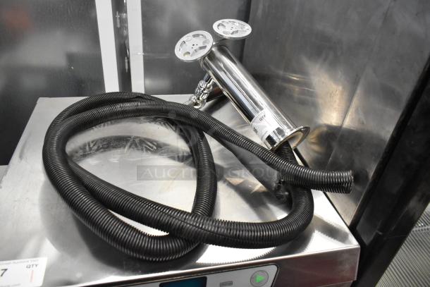 Stainless steel 2 tap beer tower with attached hoses displayed on a metal surface. Good condition, auction tag visible.