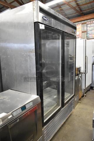 Atosa MCF8707 stainless steel 2-door reach-in cooler with poly-coated racks on commercial casters, used condition.