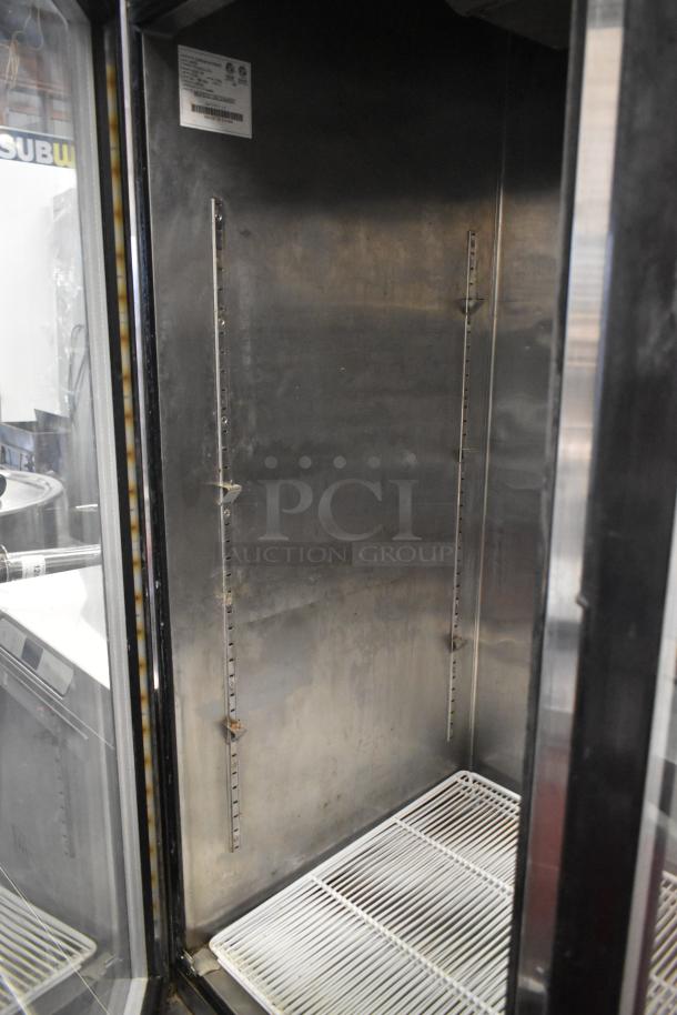 Atosa MCF8707 stainless steel commercial 2-door cooler with poly-coated racks, on casters, interior label visible.