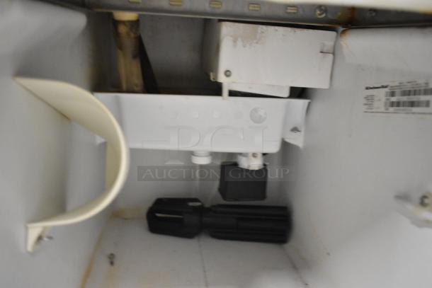 Interior view of KitchenAid KUIC15PRTS0 stainless steel ice machine, showing components and label with model details.