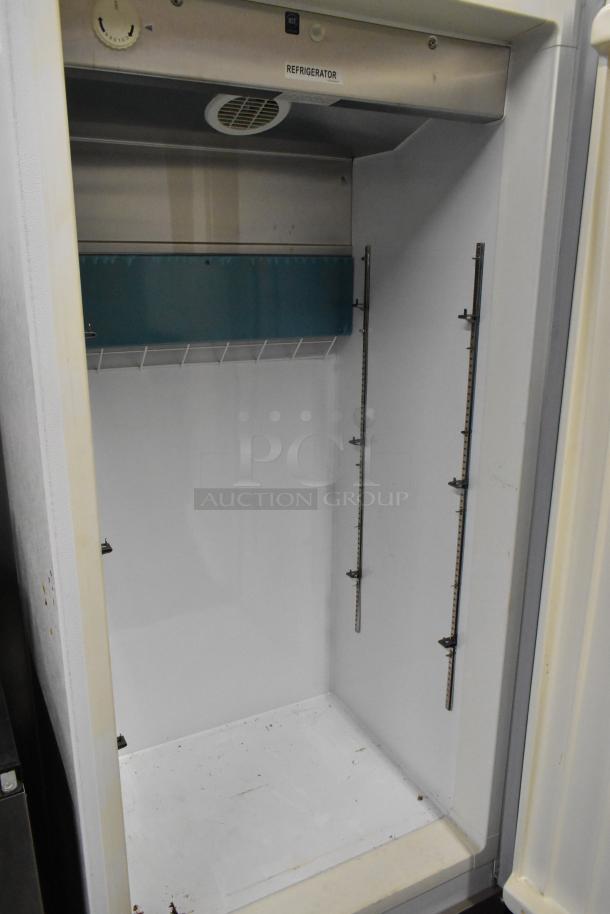 Arctic Air R22CWF6 single-door cooler, metal interior, adjustable shelving tracks, commercial casters, 115V, 1 phase.