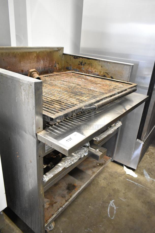 MagiKitch'n stainless steel commercial charbroiler grill, natural gas powered, well-used with visible signs of wear, item tag 137.