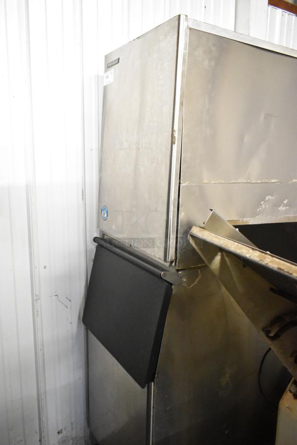 Hoshizaki KM-501MWH stainless steel commercial ice machine, 115 volts, 1 phase, on bin. Moderate wear visible.