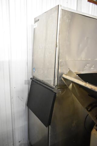 Hoshizaki KM-501MWH stainless steel commercial ice machine, 115 volts, 1 phase, on bin. Moderate wear visible.