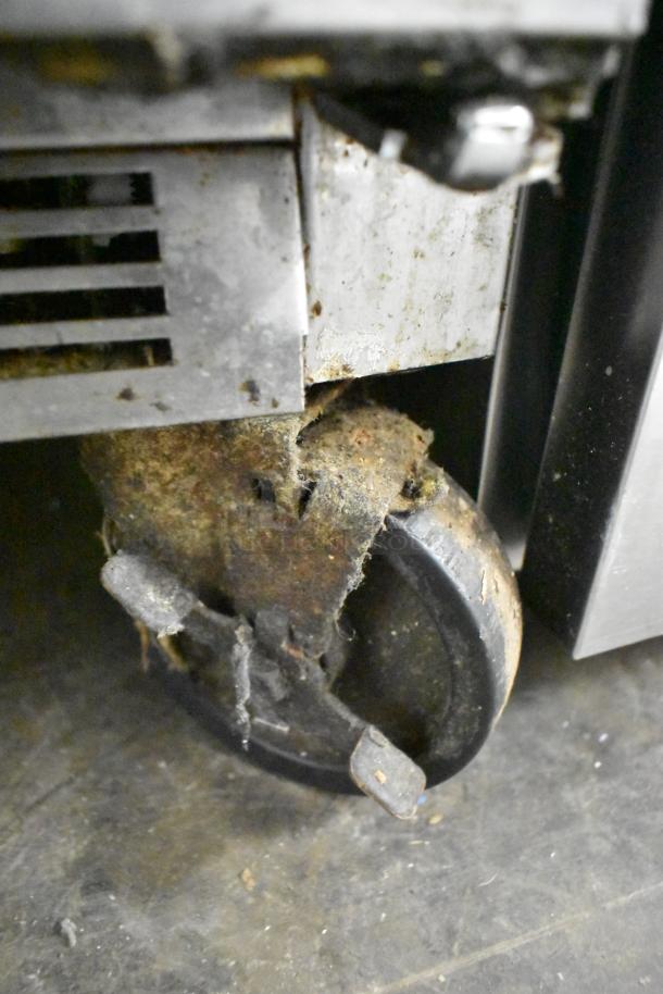 Beverage Air WTF36AHC stainless steel 2-door undercounter freezer on commercial casters. Visible wear on caster.