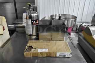 Fire extinguisher with label, WST969C divider kit in box, metal bins, on stainless surface. Pickup required.