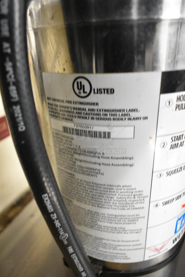 Close-up of a UL-listed wet chemical fire extinguisher label with safety instructions and barcodes visible.