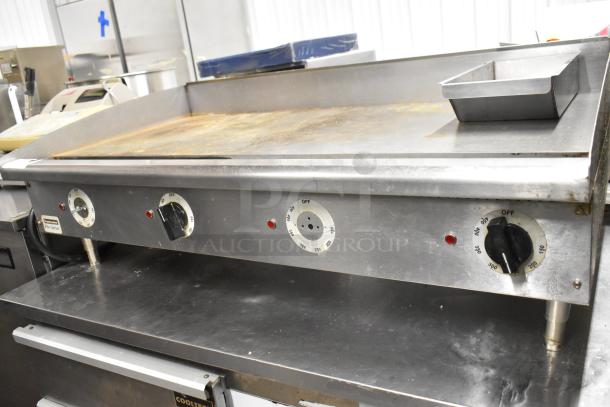 Toastmaster Pro Series stainless steel flat top griddle, commercial grade, with thermostatic controls and visible wear.