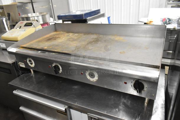 Toastmaster Pro Series stainless steel commercial griddle with thermostatic controls, visible wear, electric powered.