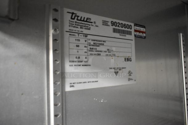 2017 True T-19F stainless steel commercial freezer with poly coated racks. Model label shows 115 volts, 1 phase. Serial 9020600.